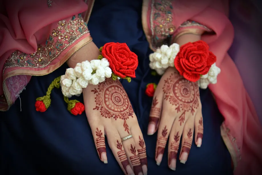 Red rose and white motia gajray on both bridal hands